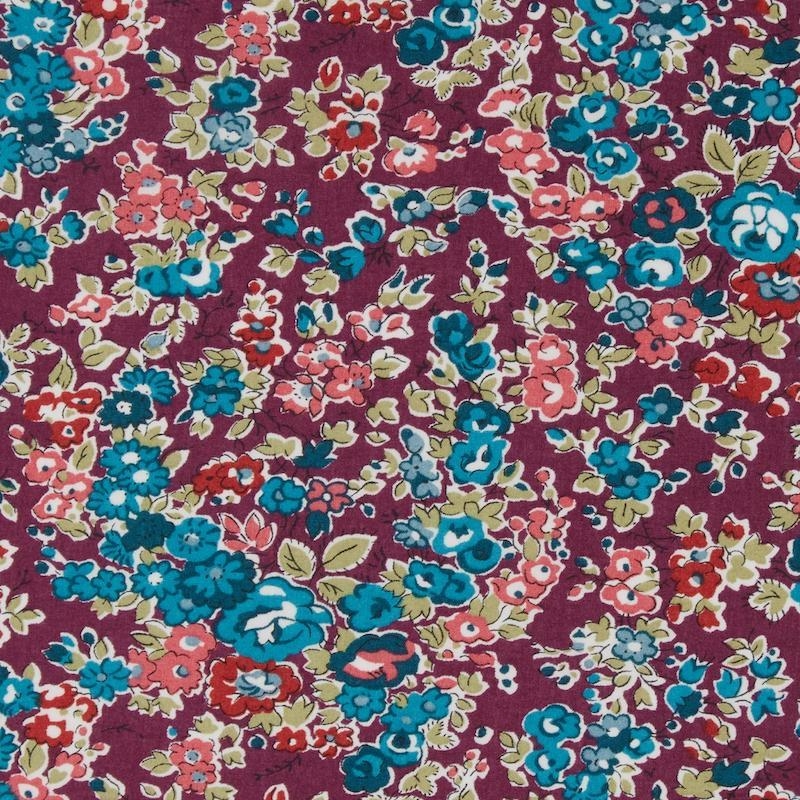 Liberty Tatum print, pink tomato red and blue flowers on a purple background